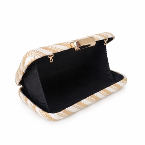 Detail of woven clutch bag showing straw wave pattern and gold metal clasp