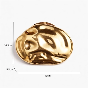 Macro shot of gold shell shaped evening bag with metallic finish showing 19cm dimensions