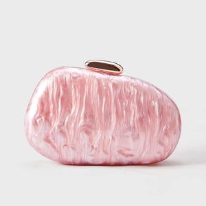 Detail of pink marble acrylic shell clutch bag with rose gold metallic clasp closure