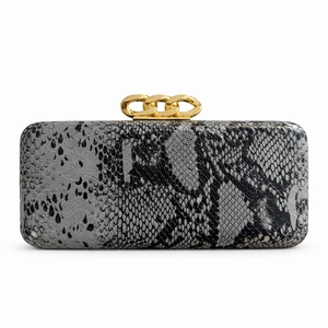 Close-up of snakeskin textured evening clutch with decorative gold chain link clasps