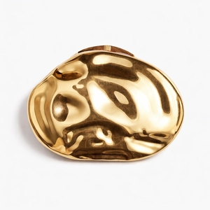 Golden irregular organic shape clutch bag with metallic lava textured finish and high mirror shine