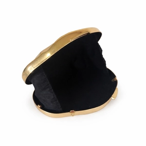 Elegant gold metal frame shell evening bag with black lining and secure snap closure