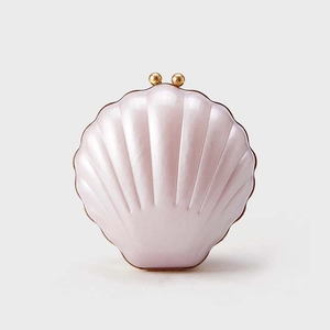 Détail de la pochette de soirée en forme de coquillage rose perlé avec fermoirs dorés