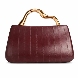 Elegant wine red PU leather handbag with luxury gold geometric handle on white background