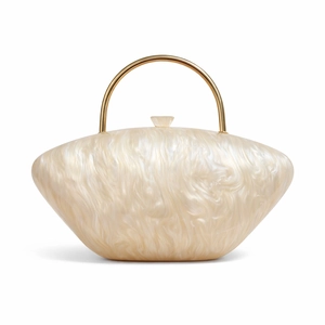 Detail of acrylic evening bag with mother-of-pearl texture and golden metal ring handle