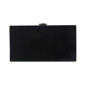 Detail showing the deep black hard shell acrylic handbag with a gold metal clasp closure