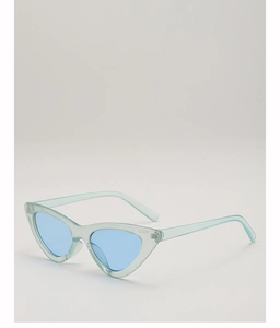 Detail view of light green cat eye sunglasses with transparent frames and blue lenses