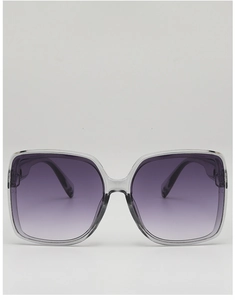 Close-up of oversized square sunglasses with purple gradient lenses and clear frames