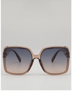 Close-up of oversized square sunglasses with gradient lenses and amber resin frame