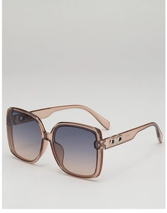 Close-up of champagne square sunglasses with gradient lenses and metal temple detail
