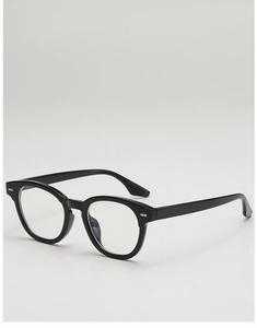 Detail view of round black eyeglass frames with high-gloss finish and anti-slip temples