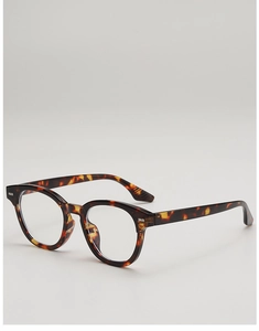 Detailed side view of round tortoise shell eyeglass frames with retro patterned texture
