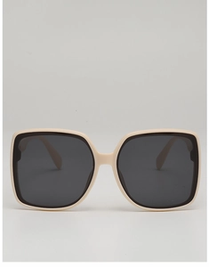 Close-up of retro oversized square sunglasses in cream beige frame with dark lenses