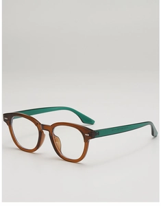 Detail of round retro glasses with brown frame and dark green semi-transparent temples