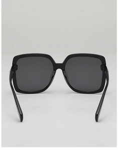 Detail view of the black oversized square sunglasses with dark grey polarized lenses