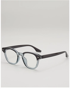 Detail view of two-tone retro round frame glasses with metallic rivet accents