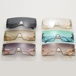 Detailed display of oversized rimless square sunglasses with hollow heart metal accents