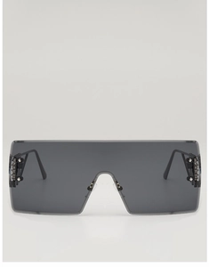 Detail view of oversized rimless square sunglasses with metallic rivets and gear accents
