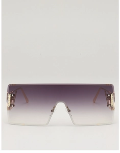 Detail of oversized rimless sunglasses with purple gradient lenses and gold gear accents