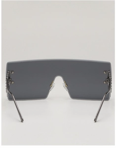 Detail of rimless square sunglasses showing metal hinges and smoke gray tinted lenses