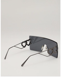 Detail of oversized rimless square sunglasses with unique heart-shaped metal hinge accents