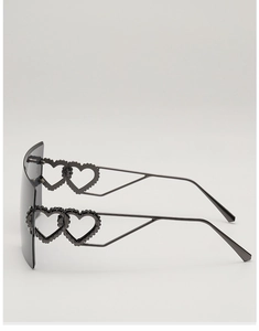Detail of hollow heart-shaped metal temples on oversized rimless square sunglasses