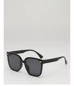 Detail of square oversized sunglasses with quilted texture temples and golden accents