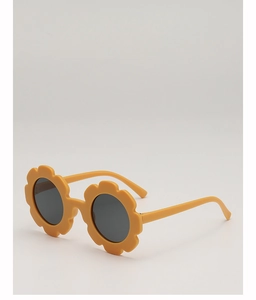 Détail de lunettes de soleil fleurs jaunes pour enfants avec des verres ronds et foncés