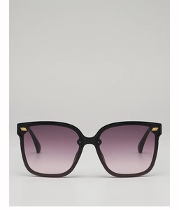 Close-up of square black sunglasses with purple gradient lenses and gold metal accents