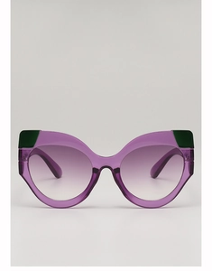 Detail of cat-eye sunglasses featuring purple gradient lenses and green color-block accents