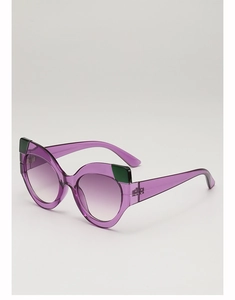 Detail view of cat eye sunglasses with transparent purple frames and green accents
