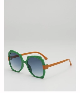 Close-up of fashion oversized sunglasses with green frames and orange temples in studio light