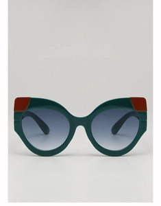 Front detail of cat eye sunglasses with dark green frames and orange color block accents