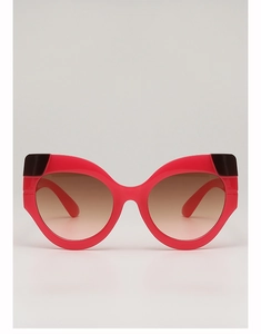 Detailed front view of red cat-eye sunglasses with gradient brown lenses and black decor