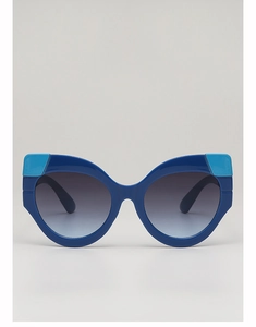 Close-up of cat-eye sunglasses with blue color-blocking frame and gradient lenses