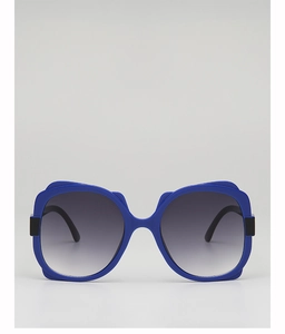 Detail of oversized sea blue sunglasses frame with grey gradient lenses and black hinges