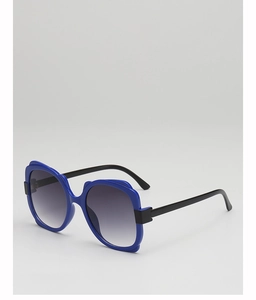 Close-up of royal blue thick frame sunglasses with grey gradient lenses and wide temples