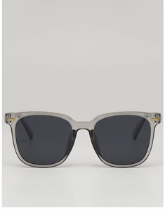 Detail of square smoke grey sunglasses with gold rivets and dark lenses