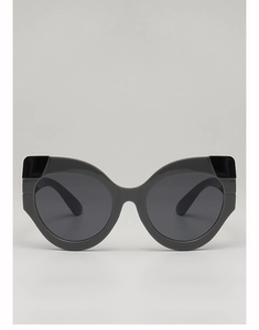 Detail of cat-eye sunglasses featuring grey lenses and contrasting black decorative frame