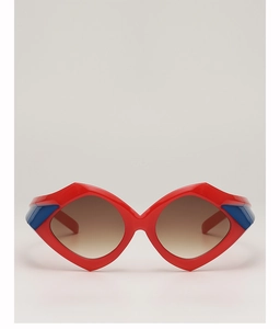 Detail of red geometric sunglasses with blue side accents and brown gradient lenses