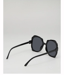 Detail view of stylish oversized black sunglasses with unique wavy frame edges