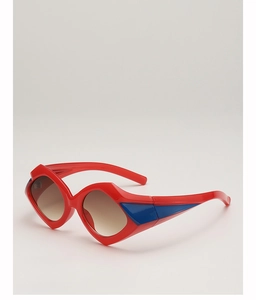 Close-up of geometric irregular sunglasses with red frames and contrasting blue temples