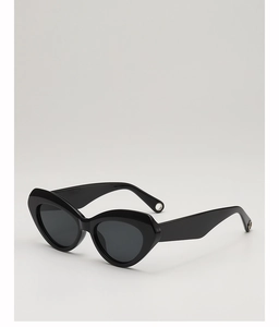 Macro view of black cat-eye sunglasses featuring detailed round metal hollow on the temple