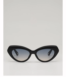 Detail view of cat eye sunglasses featuring black glossy frames and blue-grey gradient lenses