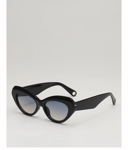 Close-up of cat-eye sunglasses with glossy black frames and blue-orange gradient lenses