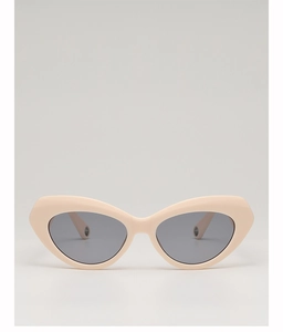 Front detail of cream cat eye sunglasses with grey lenses and a matte texture finish