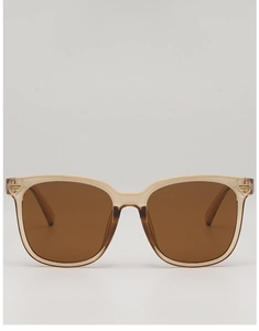 Close-up of translucent champagne frame with golden rivet details on square sunglasses