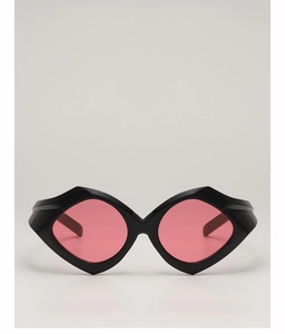 Detail of irregular geometric sunglasses with thick black frames and pink translucent lenses