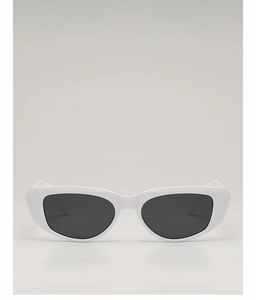 Close-up of white chunky cat-eye sunglasses with dark lenses and retro thick frame