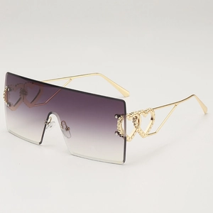 Oversize rimless sunglasses with purple gradient lenses and gold heart hollowed temples